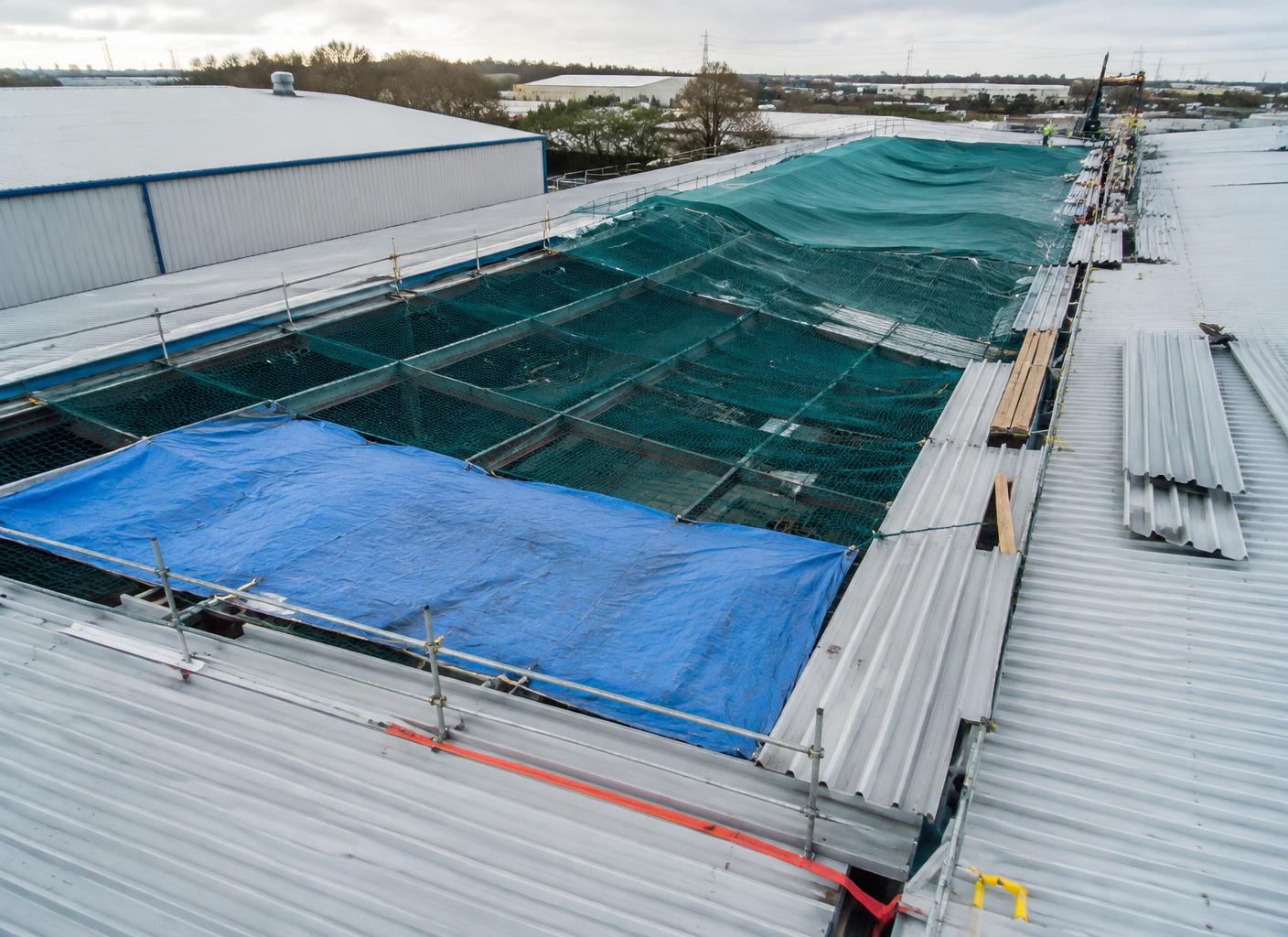 Phased roof section with temporary weather protection during a live-site replacement