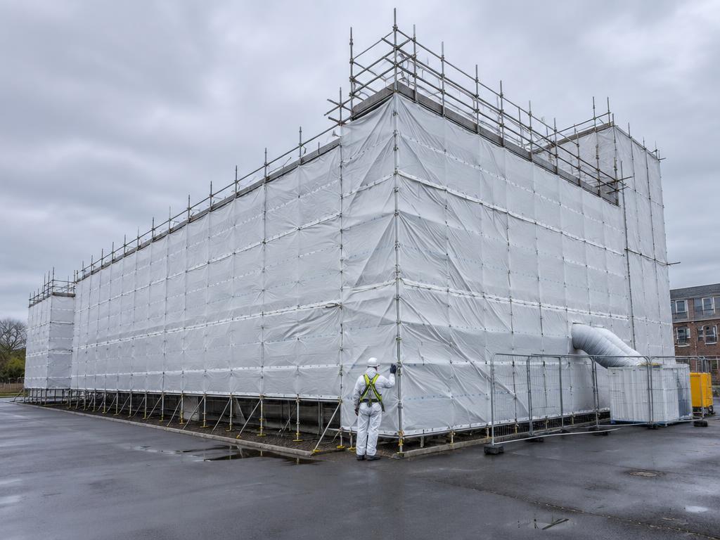 Large commercial building fully wrapped in weatherproof containment sheeting